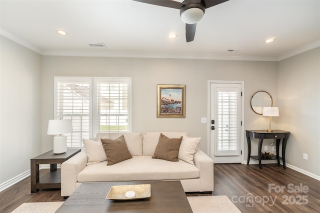 living room with dark wood-style floors, crown molding, and a ceiling fan