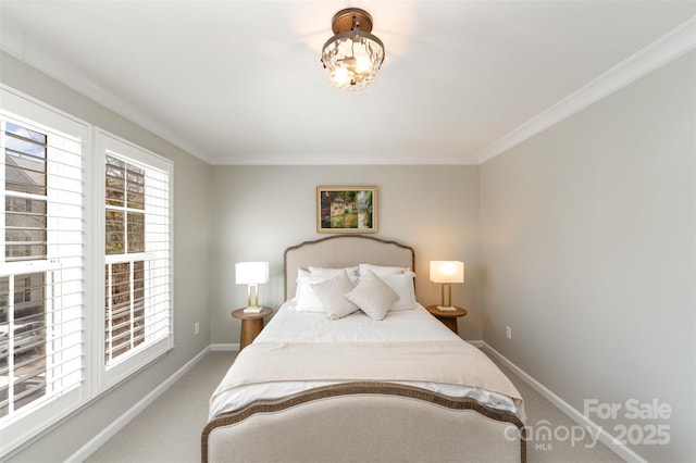 carpeted bedroom featuring baseboards and ornamental molding