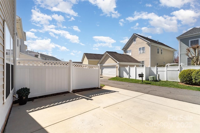 view of patio with an outbuilding, central AC unit, and a fenced backyard