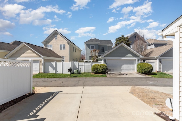 exterior space with a gate, a residential view, and fence