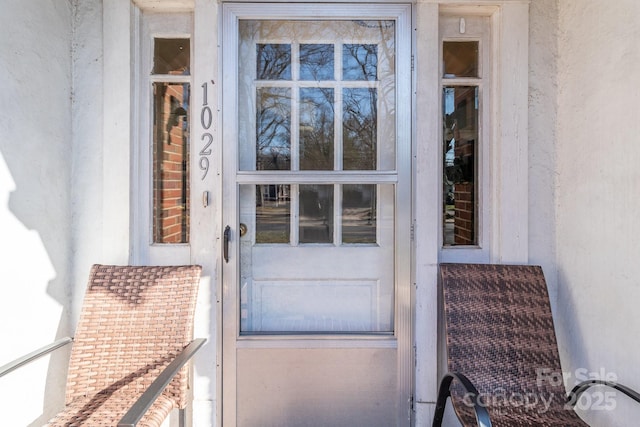 entrance to property featuring stucco siding