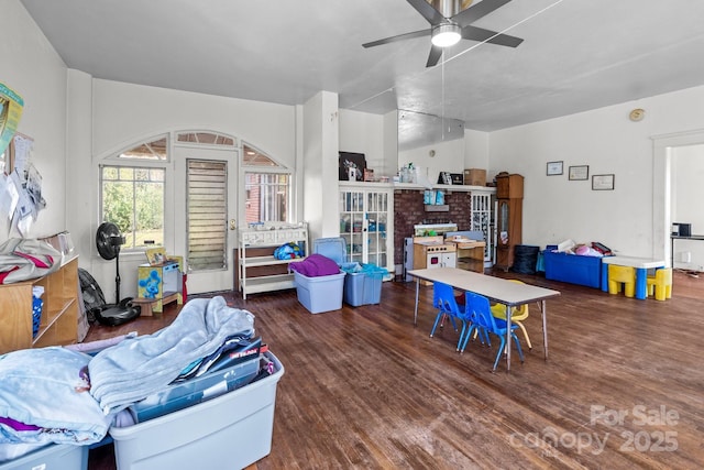 interior space with ceiling fan, wood finished floors, and a fireplace