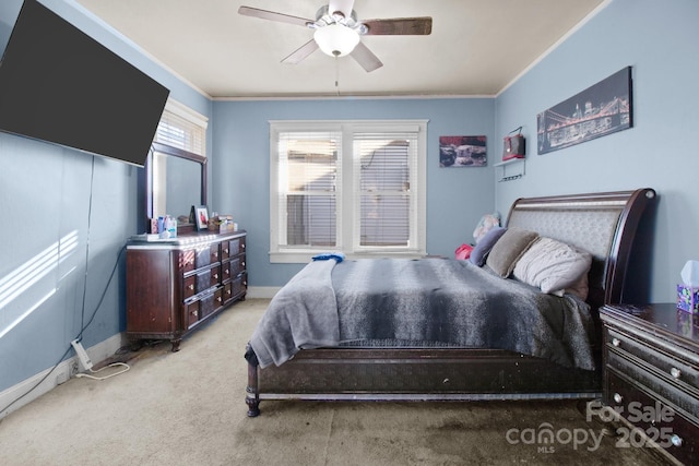 carpeted bedroom featuring crown molding, a ceiling fan, and baseboards