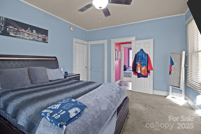 bedroom featuring crown molding, carpet flooring, baseboards, and ceiling fan