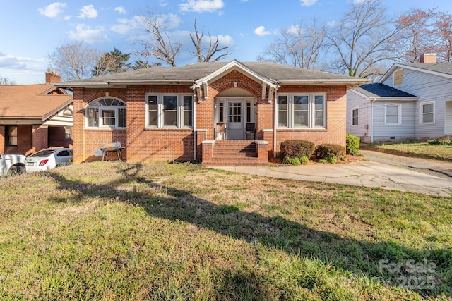 bungalow with brick siding and a front yard