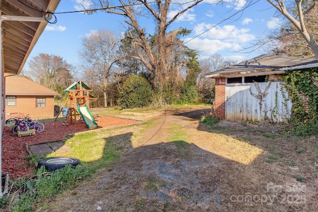 view of yard with an outbuilding and a playground