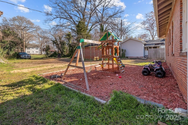 view of playground with a lawn and fence