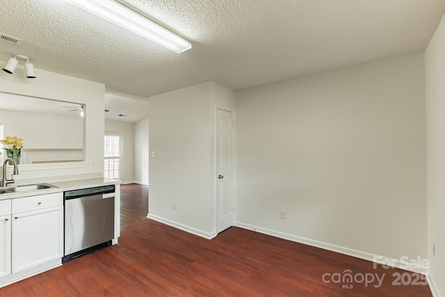 kitchen with visible vents, dark wood-type flooring, a sink, white cabinets, and dishwasher