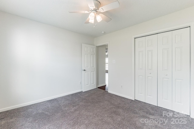 unfurnished bedroom with a closet, a ceiling fan, baseboards, and dark carpet