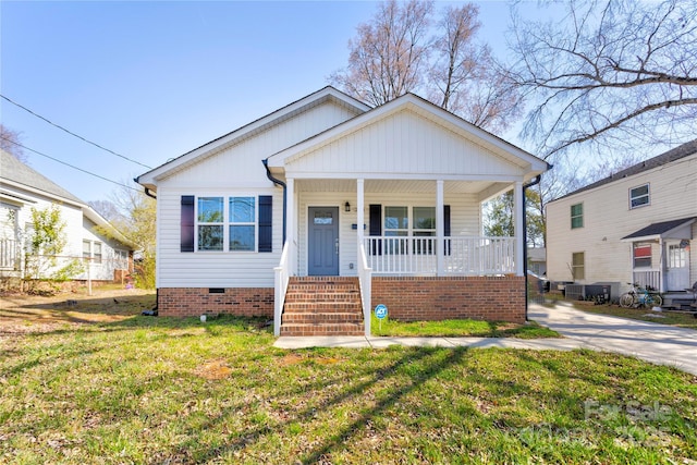 bungalow with crawl space, covered porch, and a front yard