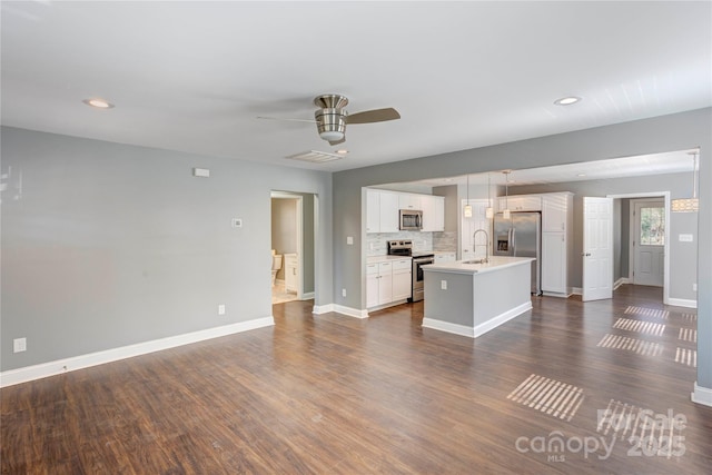 unfurnished living room featuring a ceiling fan, baseboards, visible vents, a sink, and dark wood-type flooring