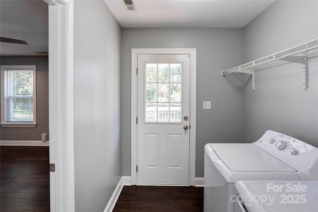 laundry area featuring visible vents, baseboards, dark wood finished floors, laundry area, and separate washer and dryer