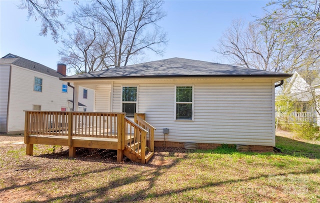 back of house with crawl space, a lawn, and a wooden deck