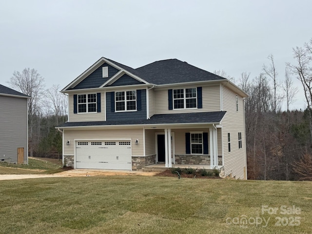 craftsman inspired home with a porch, stone siding, driveway, and a front lawn