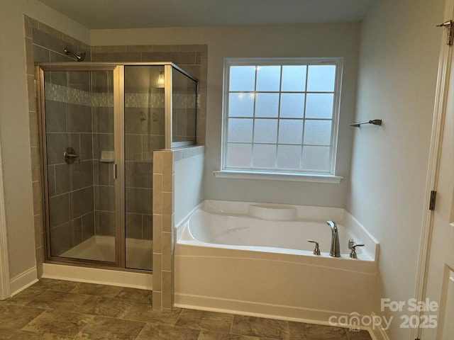 bathroom with a stall shower and a bath