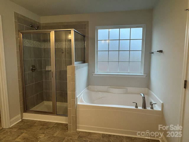 full bathroom featuring a shower stall and a bath