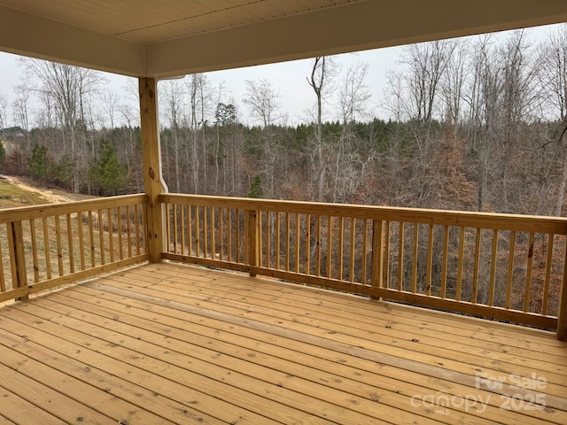 wooden deck with a view of trees