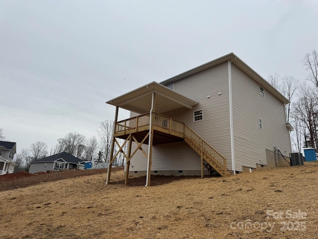 rear view of house with crawl space, cooling unit, stairs, and a deck