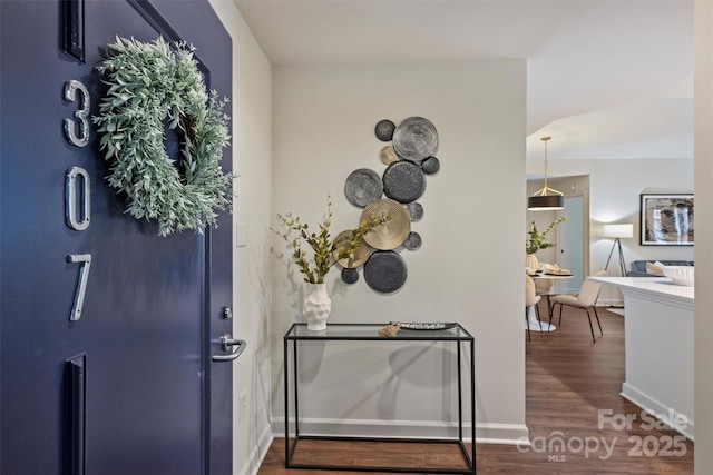 interior space with wood finished floors and baseboards