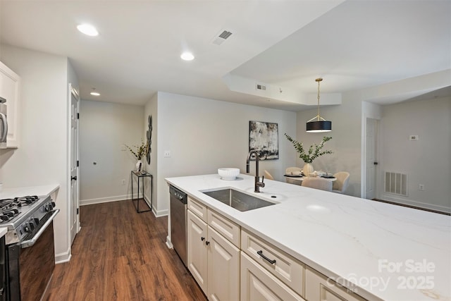 kitchen featuring visible vents, recessed lighting, gas stove, and a sink