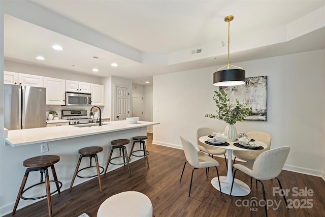 dining area with recessed lighting, visible vents, baseboards, and dark wood-type flooring