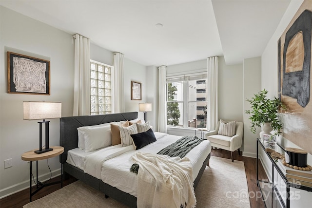 bedroom featuring wood finished floors and baseboards