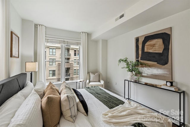 bedroom featuring visible vents and baseboards