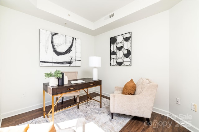 office with visible vents, baseboards, and wood finished floors