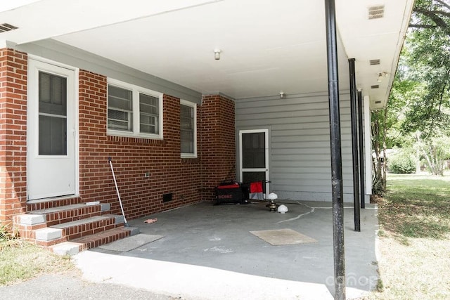 view of patio / terrace with visible vents, entry steps, and an attached carport