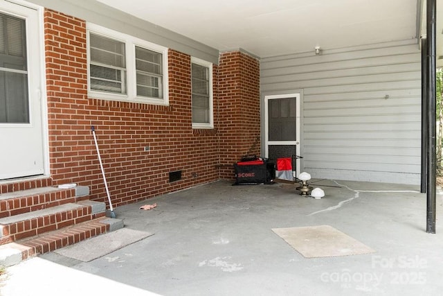 view of patio / terrace with entry steps and a carport