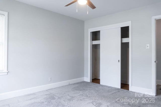 unfurnished bedroom featuring baseboards, carpet flooring, a closet, and a ceiling fan