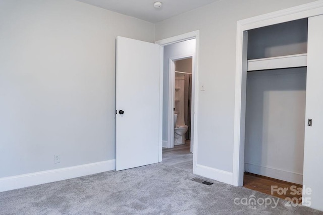 unfurnished bedroom featuring carpet flooring, a closet, visible vents, and baseboards