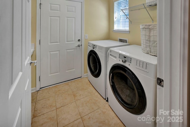 laundry area with light tile patterned floors, separate washer and dryer, and laundry area