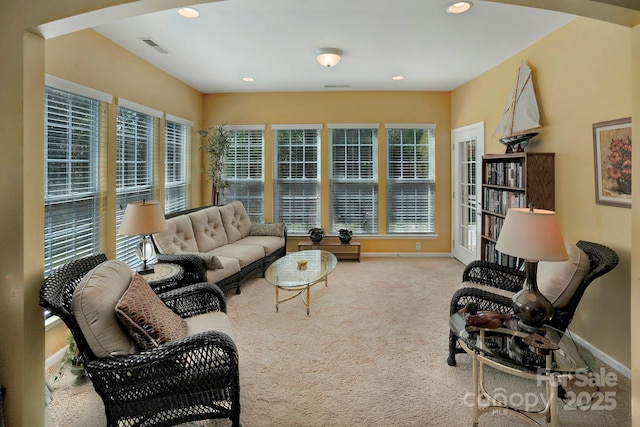 living room with recessed lighting, visible vents, baseboards, and carpet