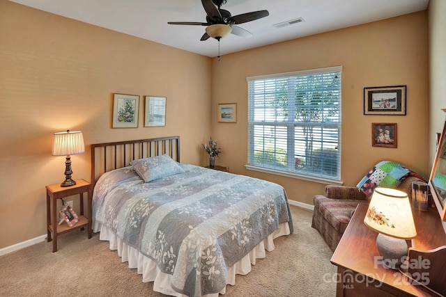 bedroom featuring visible vents, baseboards, carpet, and a ceiling fan