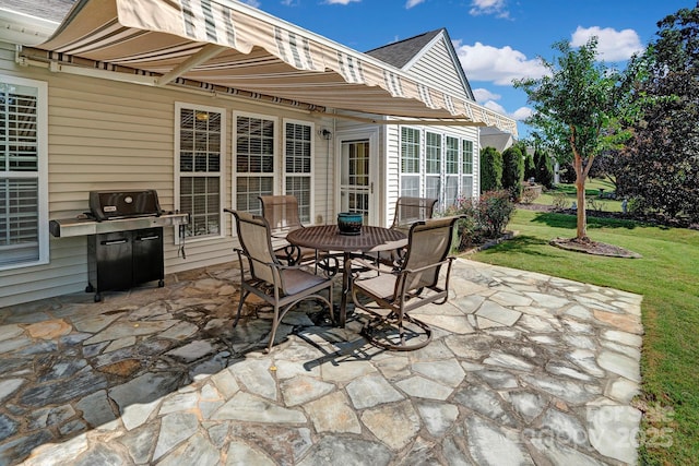 view of patio featuring outdoor dining space and a grill