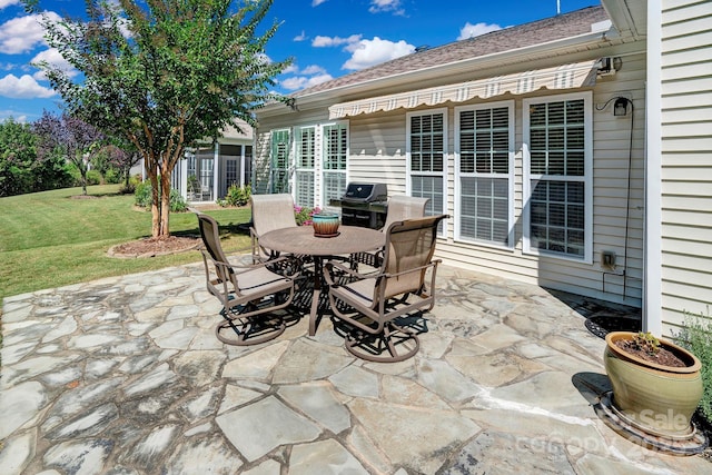 view of patio with outdoor dining space and a grill