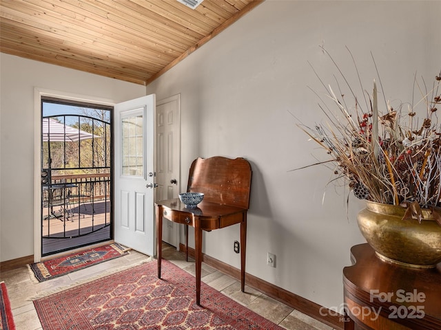 entrance foyer featuring wooden ceiling, baseboards, and vaulted ceiling