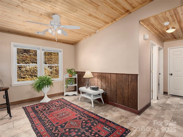 sitting room featuring baseboards, visible vents, wood ceiling, and a ceiling fan