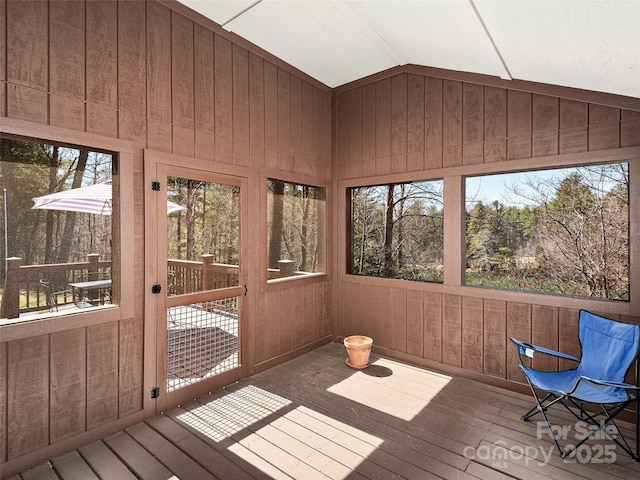 unfurnished sunroom with lofted ceiling