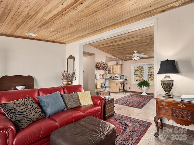 living room featuring wooden ceiling, baseboards, and ceiling fan