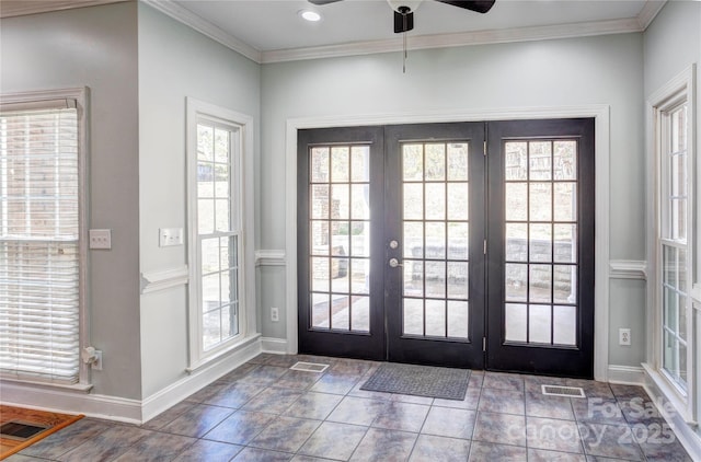 foyer with a ceiling fan, crown molding, french doors, and visible vents