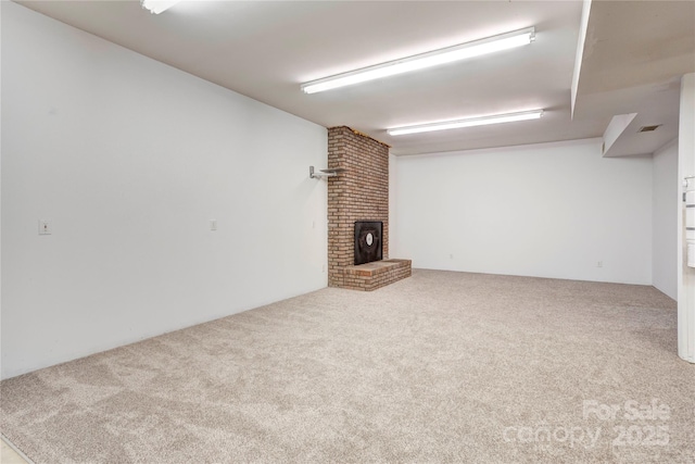 interior space featuring visible vents, carpet, and a brick fireplace