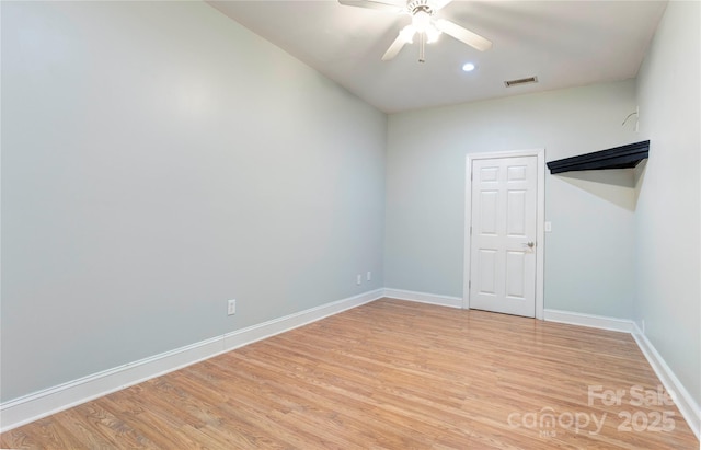 unfurnished room featuring a ceiling fan, light wood-style flooring, baseboards, and visible vents