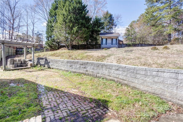 view of yard featuring a deck and fence