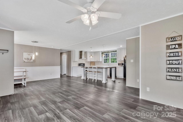living room featuring ceiling fan and dark wood-style flooring