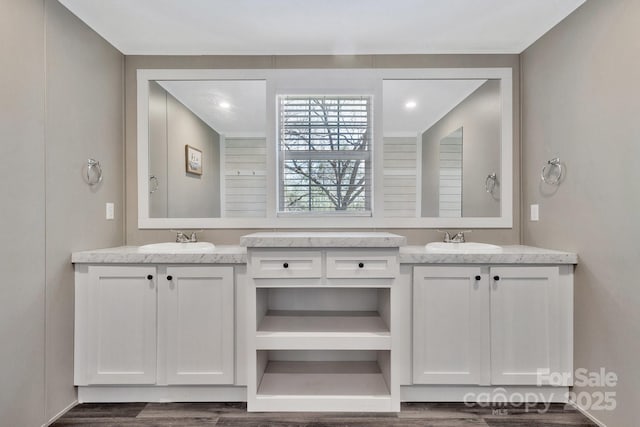 bathroom featuring a sink and two vanities
