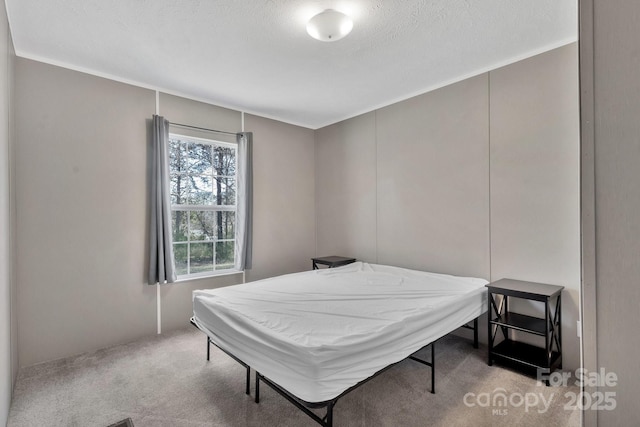 carpeted bedroom featuring a textured ceiling