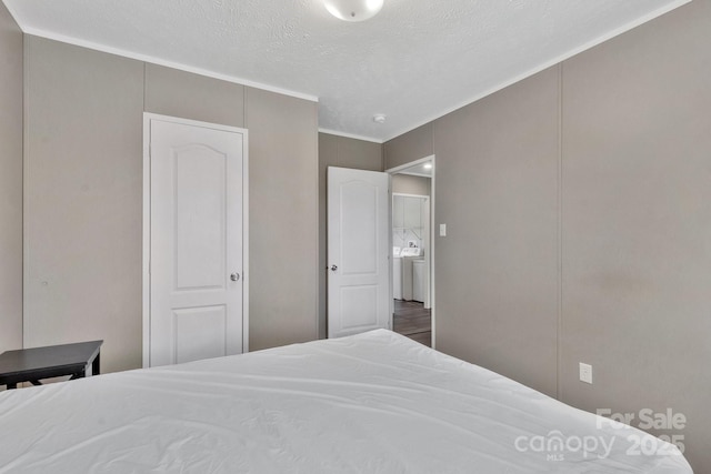 bedroom featuring crown molding and a textured ceiling