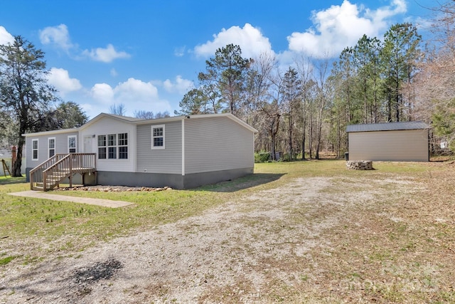 view of property exterior with a storage unit, an outbuilding, and a yard
